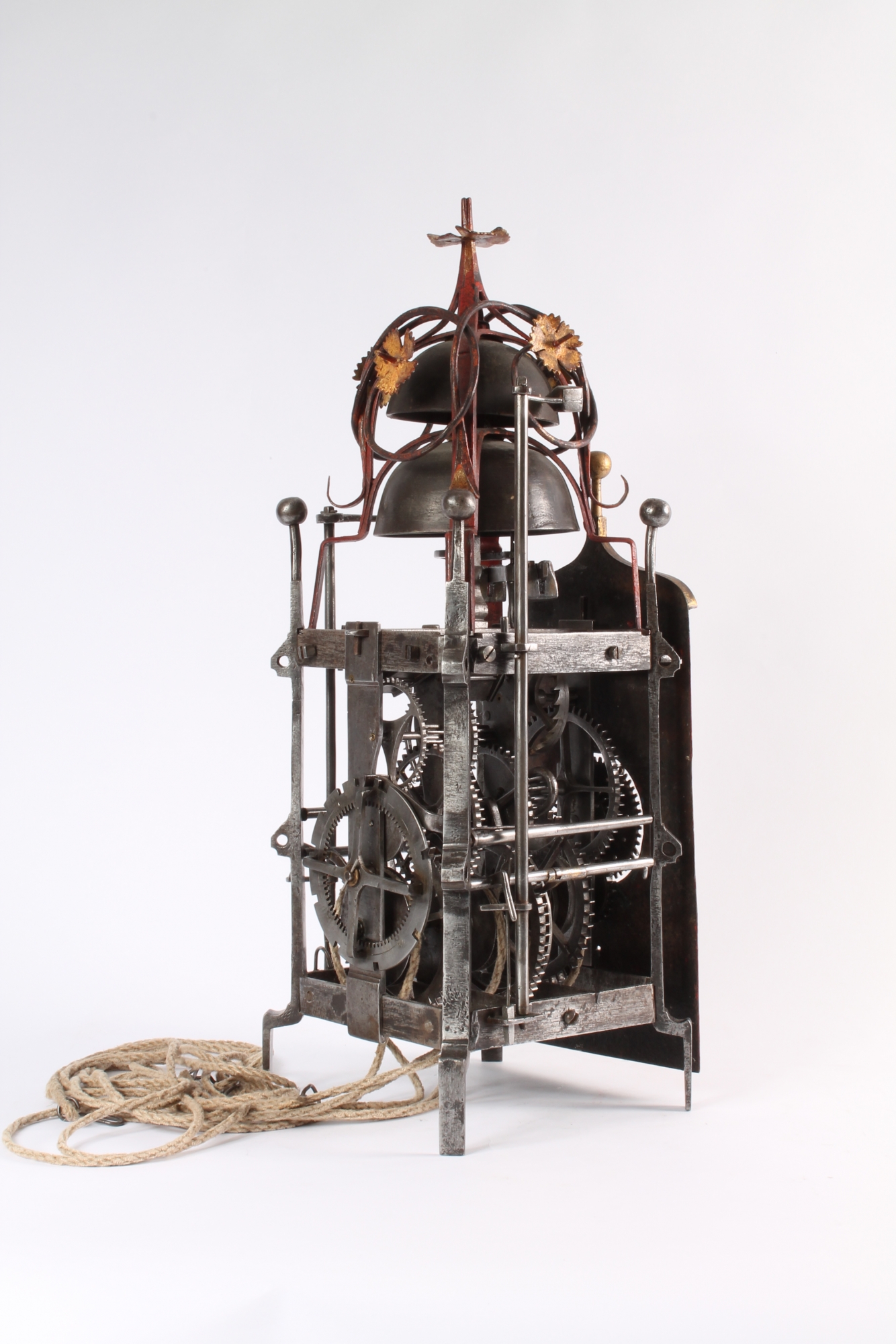 A polychrome painted iron quarter striking renaissance wall clock with