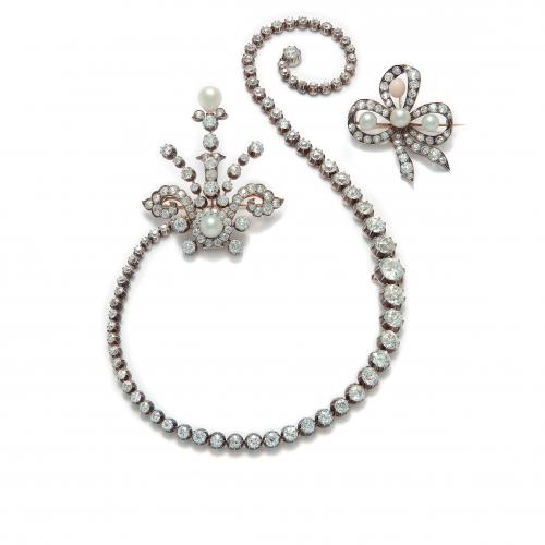 A demi-parure consisting of a necklace and two brooches, set with antique-cut diamonds