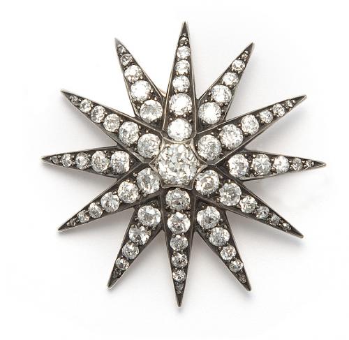 Star-shaped brooch, set with antique cut diamonds.