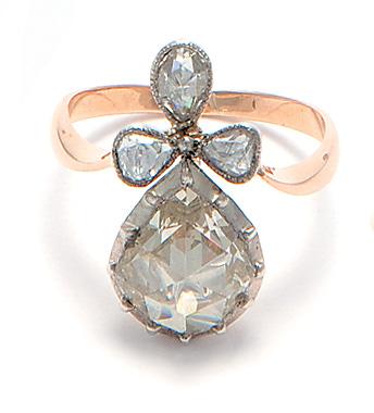 Ring, set with a pear-shaped rose-cut diamond and three smaller rose-cut diamonds.