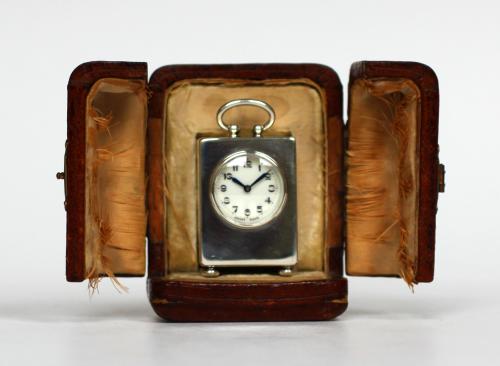 A pristine silver sub miniature carriage clock with enamel dial.