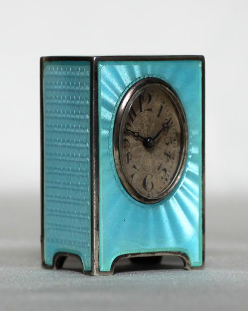 Elegant silver blue transparent enameled miniature clock of about 1900. With 8 day movement
