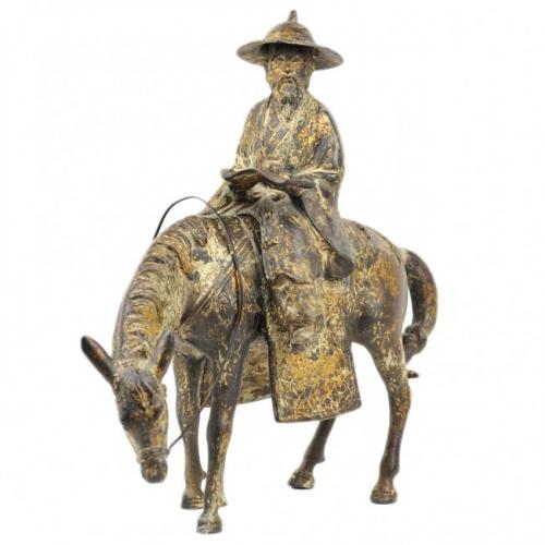 A CHINESE GILT-BRONZE SCULPTURE OF A SCHOLAR RIDING A HORSE