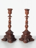 A small pair of Italian highly carved walnut single candlesticks, circa 1850