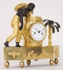 A French Empire ormolu and patinated bronze ‘au bon sauvage’ mantel clock, circa 1800.