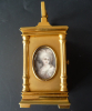 A French miniature carriage clock with two portraits, circa 1880.