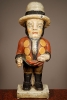 A multicoloured carved sculpture of a hunchback with remarkable buttons on his jacket, circa 1850