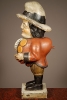 A multicoloured carved sculpture of a hunchback with remarkable buttons on his jacket, circa 1850