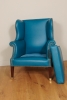 Lovely brightblue leather upholstered English wingchair.
