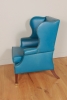 Lovely brightblue leather upholstered English wingchair.