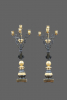 A pair of fire-gilded and patinated French Empire four-light candlesticks