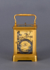 A French gilded quarter-striking carriage clock in a Corniche case with original travel case