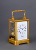 A French gilded quarter-striking carriage clock in a Corniche case with original travel case