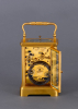 A French gilded quarter-striking carriage clock in a Corniche case with original travel case