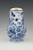 A Chinese porcelain jug with silver lid