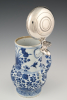 A Chinese porcelain jug with silver lid