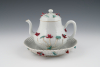 A Chinese Famille Rose teapot with the original saucer