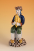 A polychrome Delftware  figure of a musician