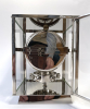 A nickel Atmos clock, J. L. Reutter, silvered dial, no. 8858, France ca. 1930.