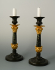A pair of ormolu and patinated candlesticks