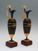 A pair of French Empire patinated bronze and ormolu ewers