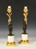 A pair of ormolu and patinated bronze candlesticks