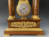 A French mahogany ormolu mounted portico mantel clock with oscillating movement, Empire ca. 1820-30.