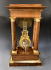 A French mahogany ormolu mounted portico mantel clock with oscillating movement, Empire ca. 1820-30.
