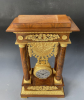 A French mahogany ormolu mounted portico mantel clock with oscillating movement, Empire ca. 1820-30.