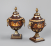 A pair of Dutch Empire tole chestnut urns