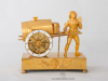 A French Empire gilt bronze mantel clock water seller, circa 1810