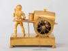 A French Empire gilt bronze mantel clock water seller, circa 1810