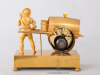 A French Empire gilt bronze mantel clock water seller, circa 1810