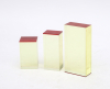 Drie optisch geslepen objecten bestaande uit geelglazen blokken met een rood vlak. Ongesigneerd. Met enkele krassen.  Herkomst: Galerie Rob van den Doel, Den Haag 1992.