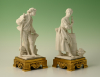 A set of two decorative biscuit-porcelain figures