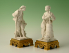 A set of two decorative biscuit-porcelain figures