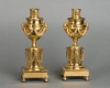 A pair of French Louis XVI ‘a double usage’ candlesticks, with rose mercury gilding