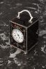 A small English tortoiseshell & silver travelling clock, by William Comyns, circa 1902