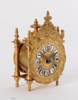 A miniature French Regence-style gilt brass table timepiece, circa 1870.