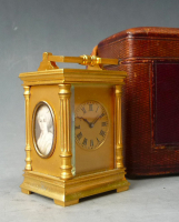 A French miniature carriage clock with two portraits, circa 1880.