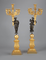 A stunning pair of French Empire gilt and patinated bronze five-light candelabra