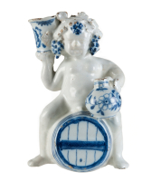 A Blue and White Dutch Delft Bacchus on Wine Barrel