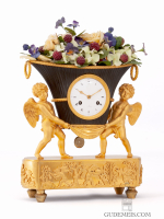 A French Empire ormolu and bronze mantel clock, putti with flower urn, circa 1800