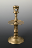 A bronze collar candlestick