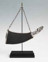 A silver powder horn clad in sharkskin