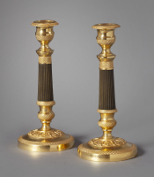 A pair of ormolu and bronze Charles Dix candlesticks