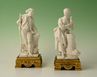 A set of two decorative biscuit-porcelain figures