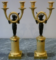 A pair of gilt and patinated candelabra