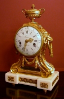 A gilt bronze and white marble mantleclock