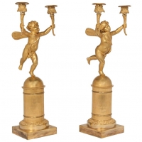 A pair of two armed empire ormolu candlestick with Cupids, Circa 1820